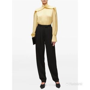 The Row Francis High-Rise Wool Tapered-Leg Trousers.They're crafted in the USA